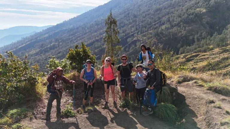 6 Hikers pause with their guide on their way up Mt. Rinjani.