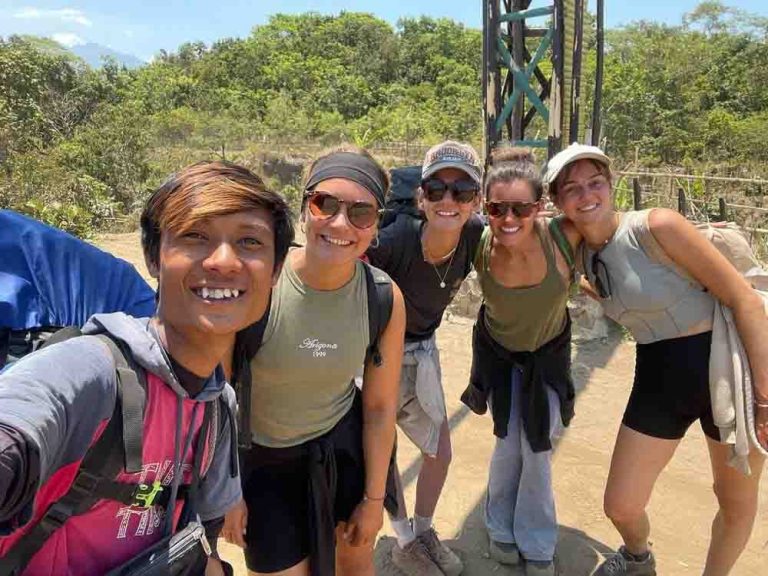 Four hikers pose with their guide on their way up Mt. Rinjani