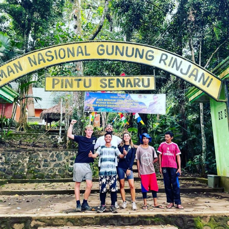 Hikers pose with their guide at the Senaru Route entrance to Mt. Rinjani National Park